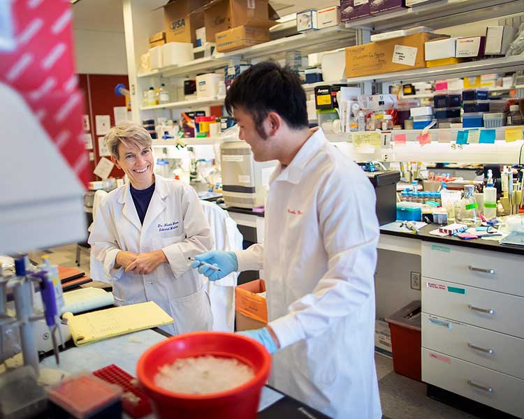 Dr. Mason and student in cancer research lab